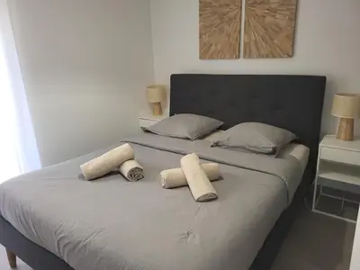a bedroom with a bed with a ceiling fan at Prestige View 103 By Avecoeur in Èze