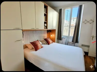 a bedroom with a large white bed and a window at Central close to beaches and shops, up till 6 pers in Nice