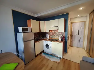 a kitchen with a white refrigerator and a dishwasher at Central close to beaches and shops, up till 6 pers in Nice