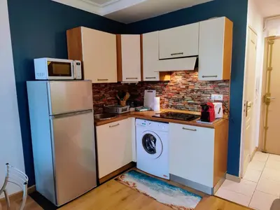a kitchen with a refrigerator and a washer at Central close to beaches and shops, up till 6 pers in Nice