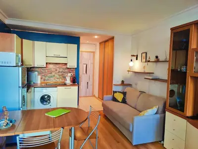 a kitchen and living room with a couch and a table at Central close to beaches and shops, up till 6 pers in Nice