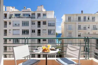 a table with food on a balcony with buildings at The place to be in Nice in Nice