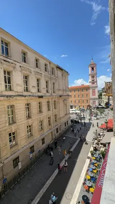 a city street with a building and a clock tower at Duplex spagiari in Nice