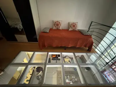 a bedroom with a bed and a glass floor at Duplex spagiari in Nice