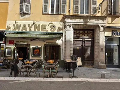 a restaurant with tables and chairs outside of a building at Duplex spagiari in Nice