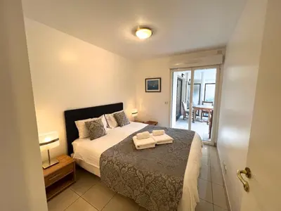 a bedroom with a bed with two towels on it at Sunlight Properties - Mirage - Central Nice with Parking and Terrace in Nice