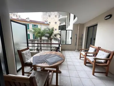 a balcony with a table and chairs and a window at Sunlight Properties - Mirage - Central Nice with Parking and Terrace in Nice