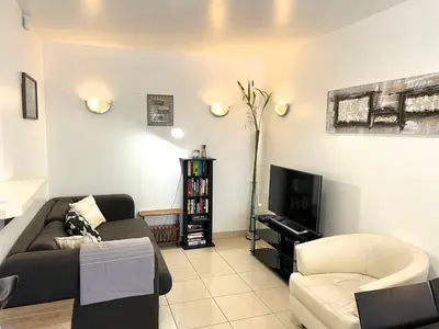 a living room with a couch and a tv at Sunlight Properties - Mirage - Central Nice with Parking and Terrace in Nice