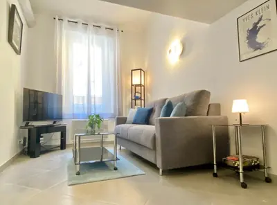 a living room with a couch and a table at Duplex Cosy au Cœur du Vieux-Nice in Nice