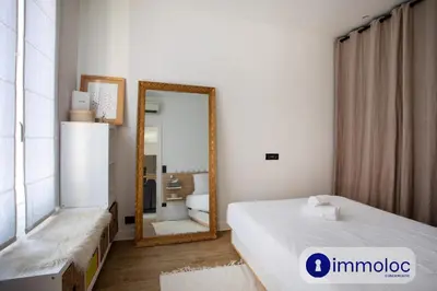 a bedroom with a mirror and a bed and a mirror at Apartment T2 Air-conditioned district Libération in Nice