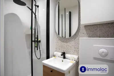 a bathroom with a sink and a shower with a mirror at Apartment T2 Air-conditioned district Libération in Nice