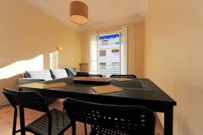 a dining room with a table and chairs and a couch at Chic & Spacious Getaway in Nice - 10min to Beach in Nice