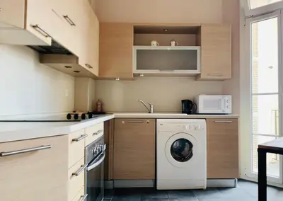 a kitchen with a washing machine and a microwave at Chic & Spacious Getaway in Nice - 10min to Beach in Nice