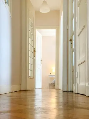 an empty hallway with an open door and wooden floors at Chic & Spacious Getaway in Nice - 10min to Beach in Nice