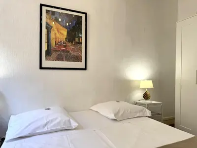 a bedroom with a white bed with a picture on the wall at ApartHotel Riviera - BARILLERIE 4 - 3 pieces - Old Town Promenade Anglais in Nice