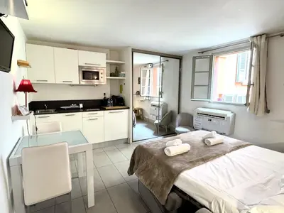 a kitchen with a bed and a table in a room at ApartHotel Riviera - MALONAT 3 - Grand Studio très calme -Old Town Promenade des Anglais in Nice