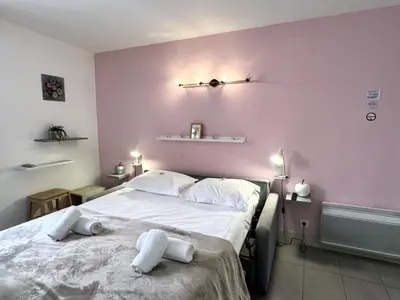 a bedroom with a large bed with towels on it at ApartHotel Riviera - MALONAT 3 - Grand Studio très calme -Old Town Promenade des Anglais in Nice
