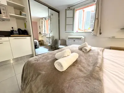 a bedroom with a bed with towels on it at ApartHotel Riviera - MALONAT 3 - Grand Studio très calme -Old Town Promenade des Anglais in Nice