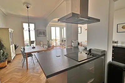 a kitchen and dining room with a table and a stove at Le Palais Riviera in Nice
