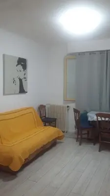a bedroom with a bed and a table and chairs at Nice Charmant 2 pièces in Nice