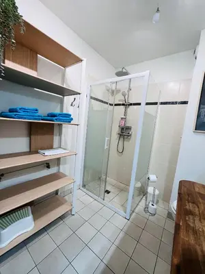 a bathroom with a shower with a glass door at Studio terrasse et parking privé in Nice