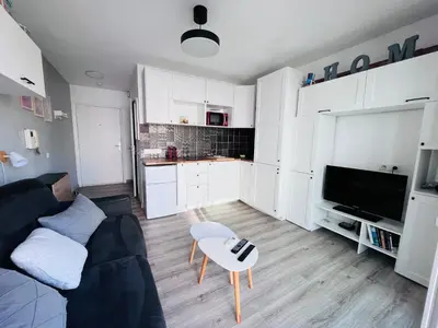 a living room with a couch and a table at Studio terrasse et parking privé in Nice