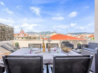 a table on a balcony with a view of a city at Apartment Les terrasses de l'Escurial by Interhome in Nice