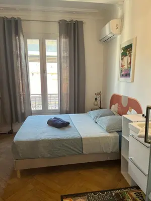 a bedroom with a bed and a window at Les chambres de Cédric ICONIC TRAM GARE Nice Ville pour personnes CALMES in Nice