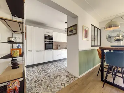 a kitchen with white cabinets and a table and blue chairs at Nestor&Jeeves - SUN DECK TERRACE - Top Floor in Nice
