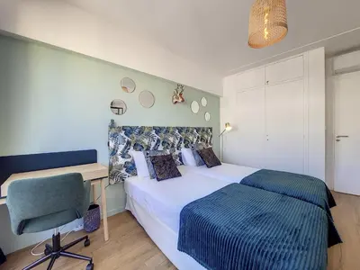 a bedroom with a bed and a desk and a chair at Nestor&Jeeves - SUN DECK TERRACE - Top Floor in Nice