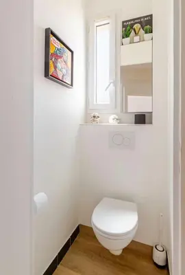 a white bathroom with a toilet and a window at Cosy appartement, Vue Mer panoramique in Nice