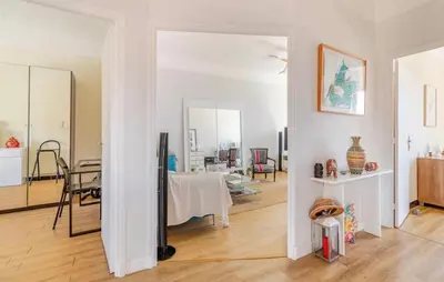 a living room with a table and a mirror at Cosy appartement, Vue Mer panoramique in Nice