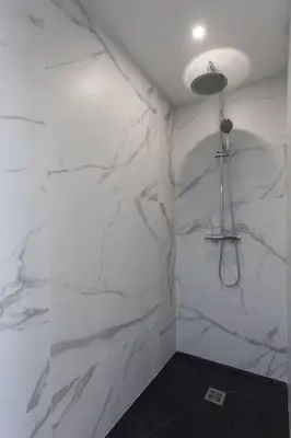 a bathroom with white marble walls and a light at Echapée Belle - Vinayard view - Jacuzzi BBQ - parking in Nice