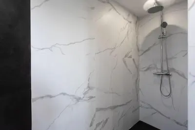 a bathroom with white marble walls and a shower at Echapée Belle - Vinayard view - Jacuzzi BBQ - parking in Nice