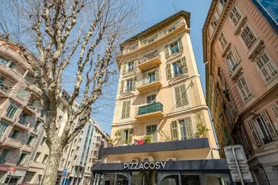 a tall building with a sign in front of it at La Cachette du Port! -Avec parking au Port de Nice in Nice