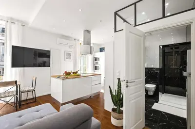 a living room with a couch and a kitchen at La Cachette du Port! -Avec parking au Port de Nice in Nice