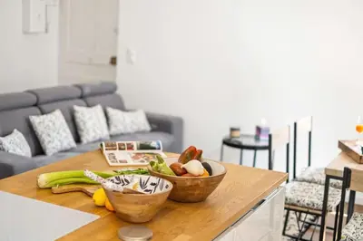 a kitchen with two bowls of vegetables on a table at La Cachette du Port! -Avec parking au Port de Nice in Nice