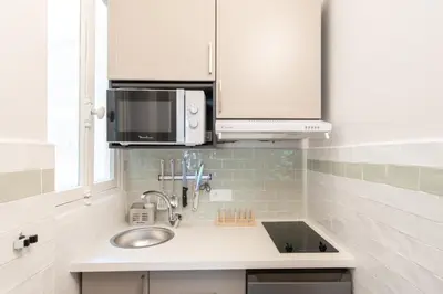 a kitchen with a sink and a microwave at 26 Nice Parc Imperial studio in Nice