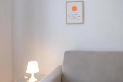a living room with a chair and a lamp at 26 Nice Parc Imperial studio in Nice