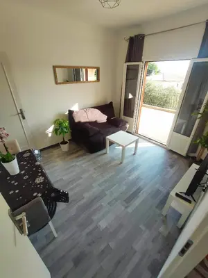 a living room with a couch and a table at Les studios des mandariniers in Cagnes-sur-Mer