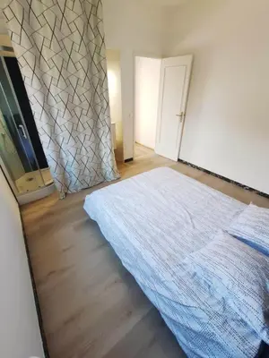 a bedroom with a bed and a wall at Les studios des mandariniers in Cagnes-sur-Mer