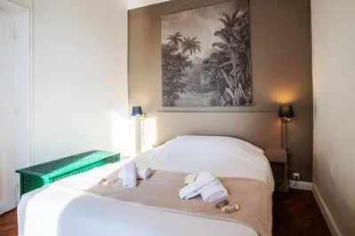 a bedroom with a bed with towels and dolls on it at Villa Reve d azur vi4353 by Riviera Holiday Homes in Nice