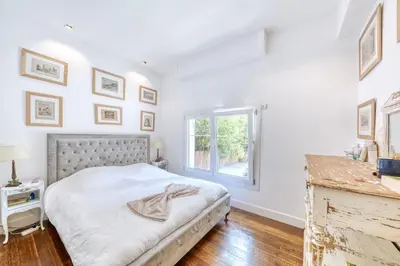 a white bedroom with a bed and a window at Peaceful Haven, Terrace in Nice in Nice