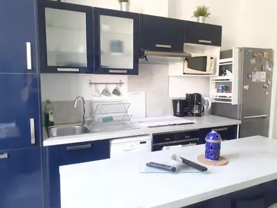 a kitchen with black cabinets and a white counter top at 2 Pièces Neuf WIFI Quartier Borriglione in Nice