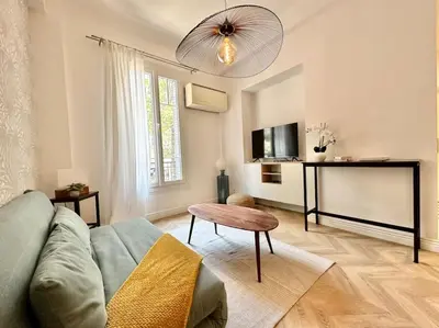 a living room with a couch and a table at Magnifique appartement moderne - Clim & Wifi in Nice