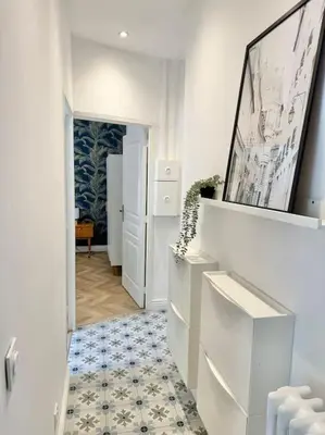 a hallway with a room with white walls and a floor at Magnifique appartement moderne - Clim & Wifi in Nice