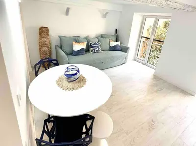a living room with a white table and a couch at Nouveau - Nice Mamac - centre in Nice