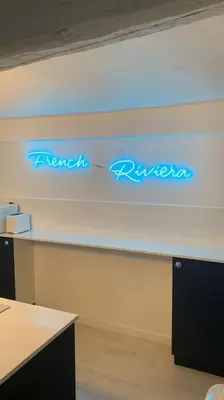 a room with blue neon signs on the wall at Nouveau - Nice Mamac - centre in Nice