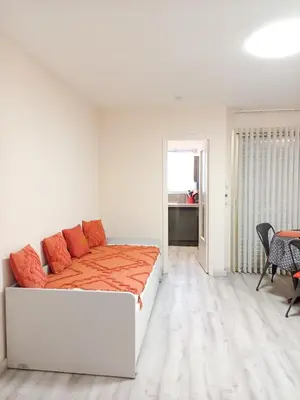 a bedroom with a bed and a table and chairs at Rose Garden in Cagnes-sur-Mer