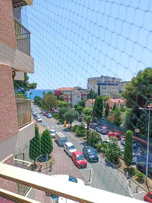 a view of a busy city street with cars parked at Rose Garden in Cagnes-sur-Mer